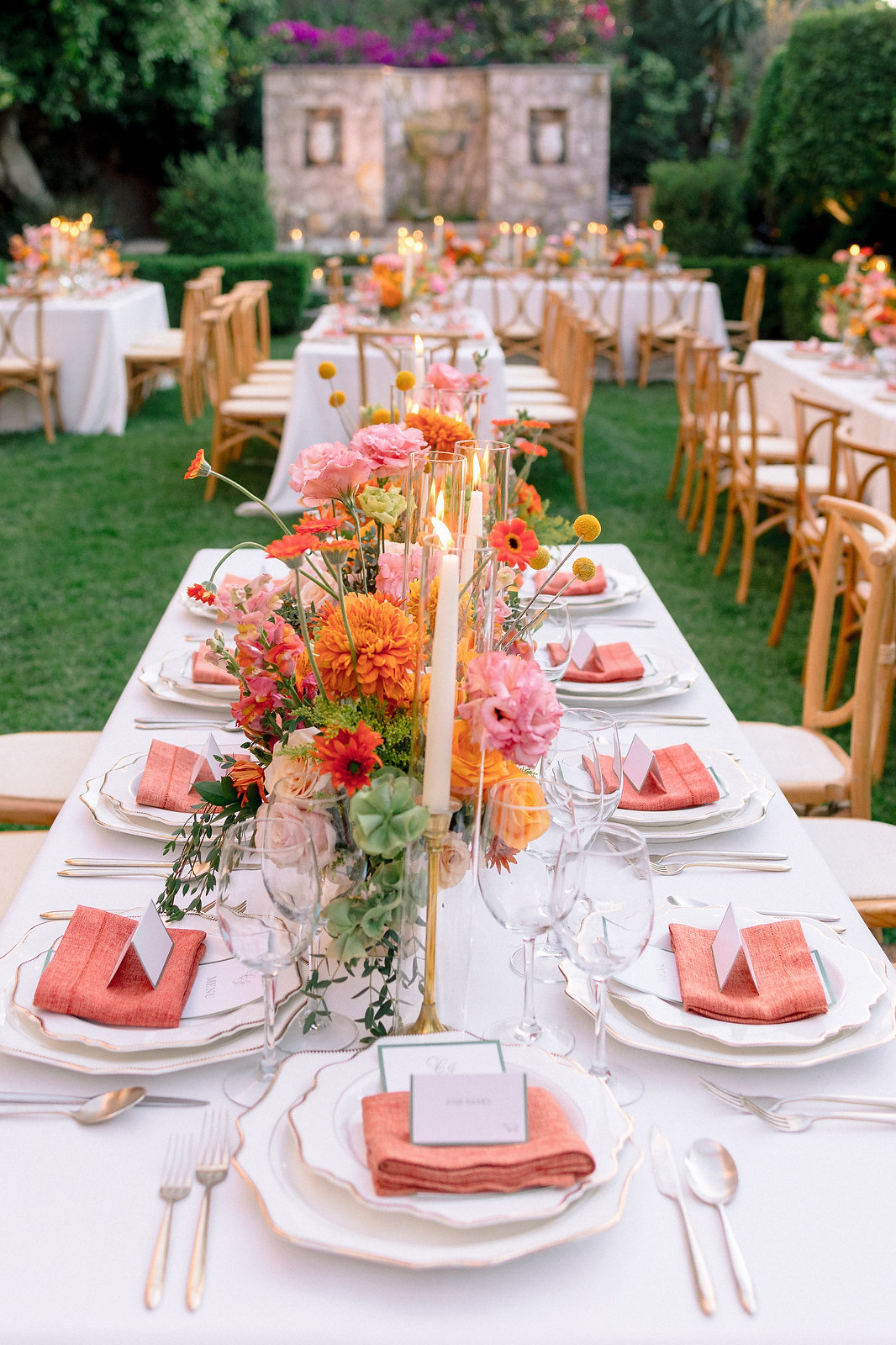 Colorful reception table setting with dahlias and coral napkins at San Miguel de Allende wedding
