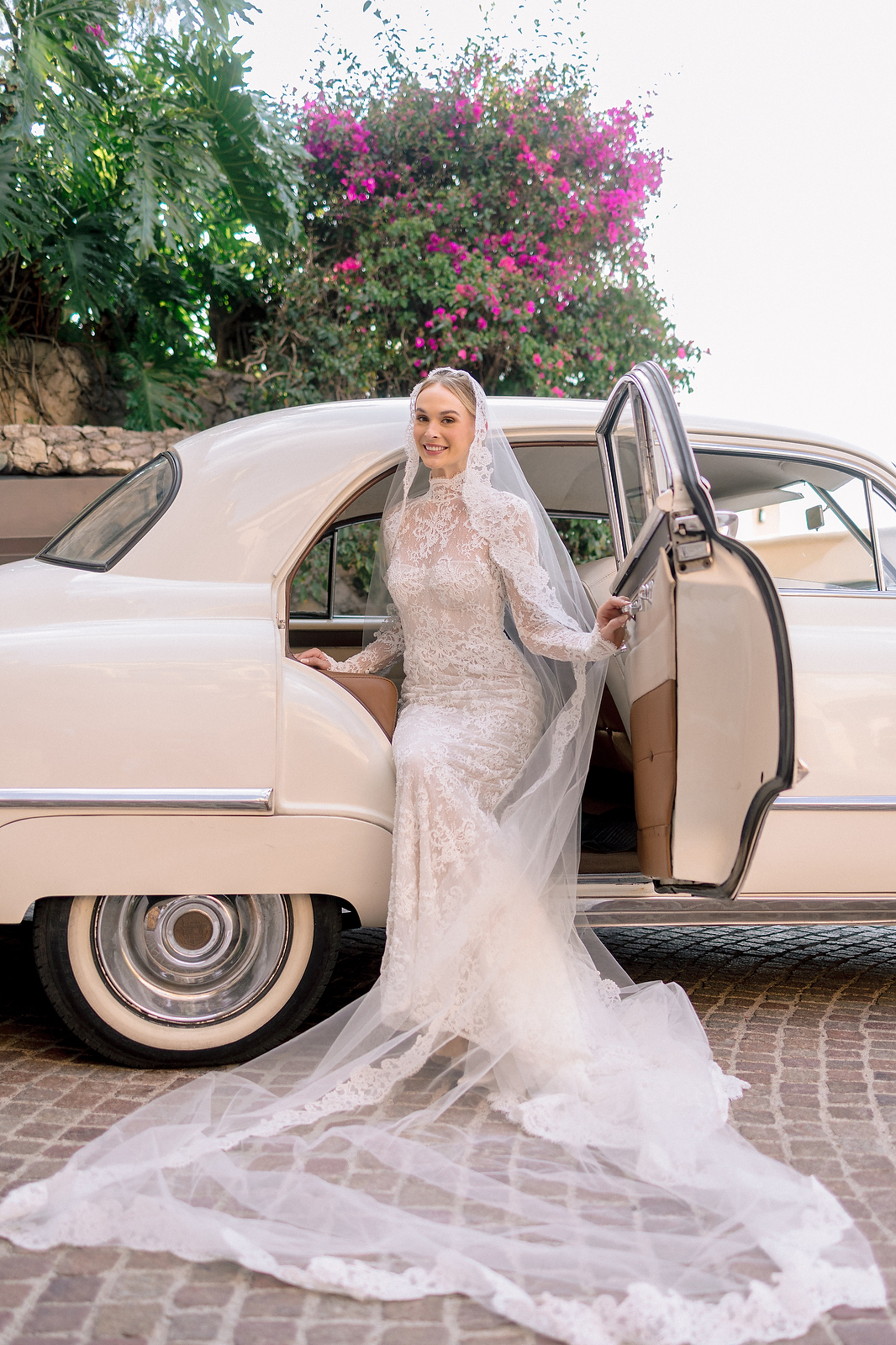 Bride with vintage car departing for church ceremony in San Miguel de Allende