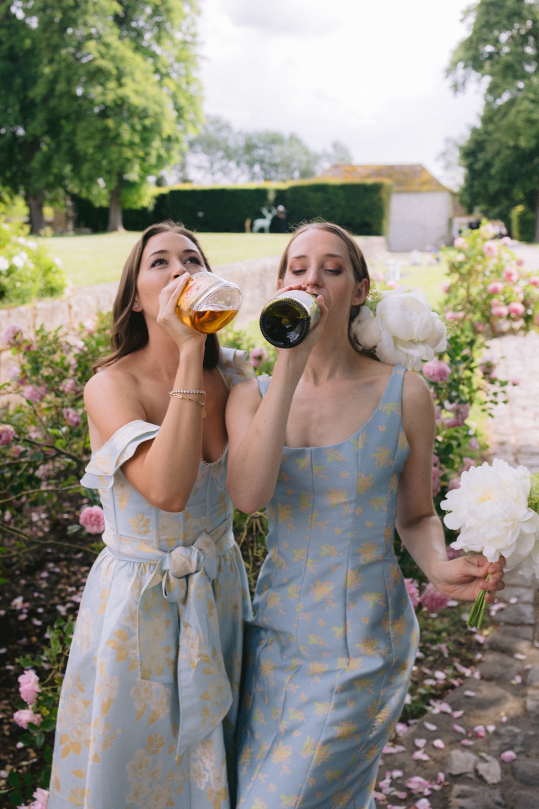 Bridesmaids with champagne in French chateau garden wedding