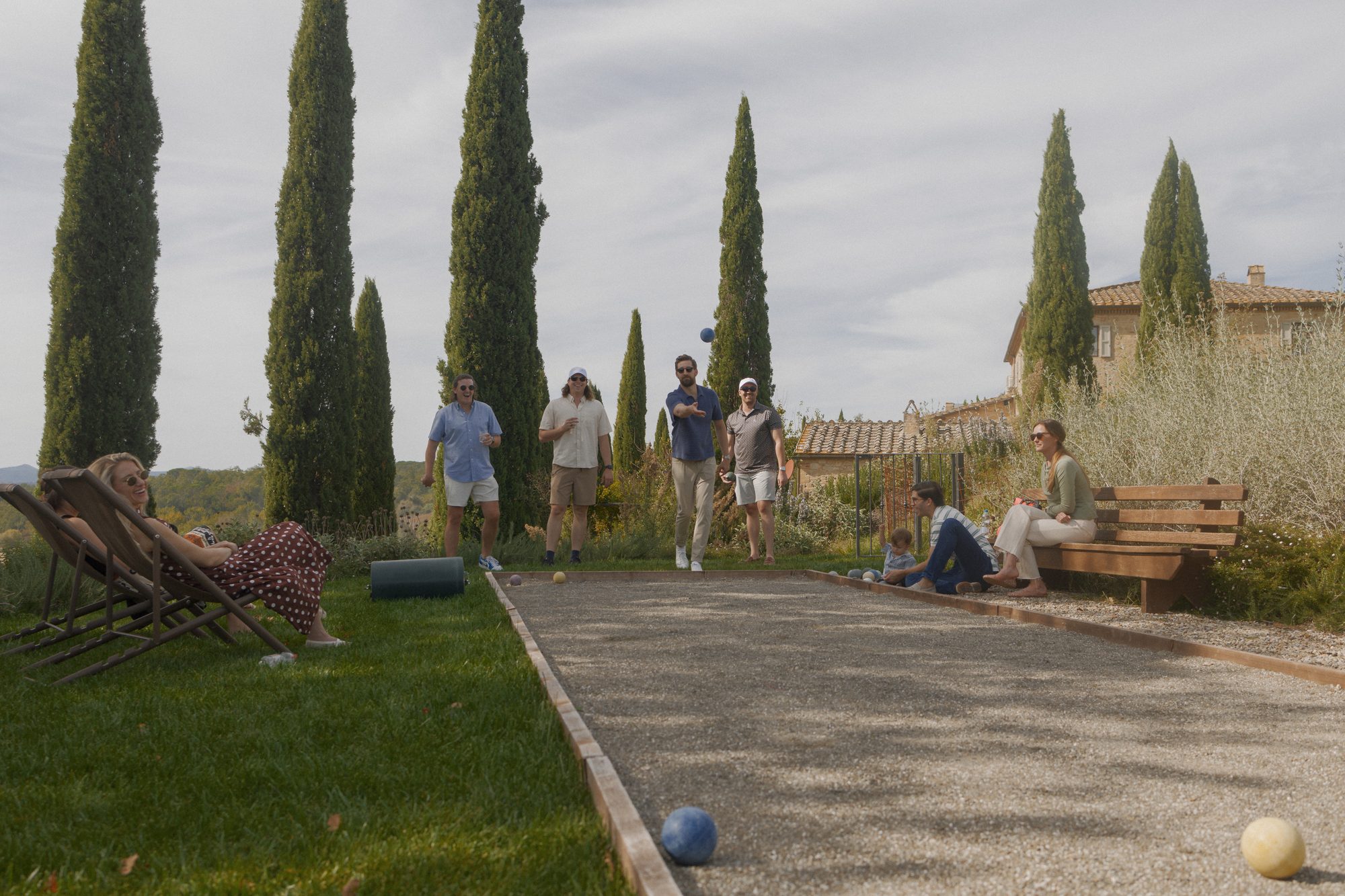 Al fresco dinner toast at Ombroneta Villa Tuscany destination wedding by Marco Wang Photography