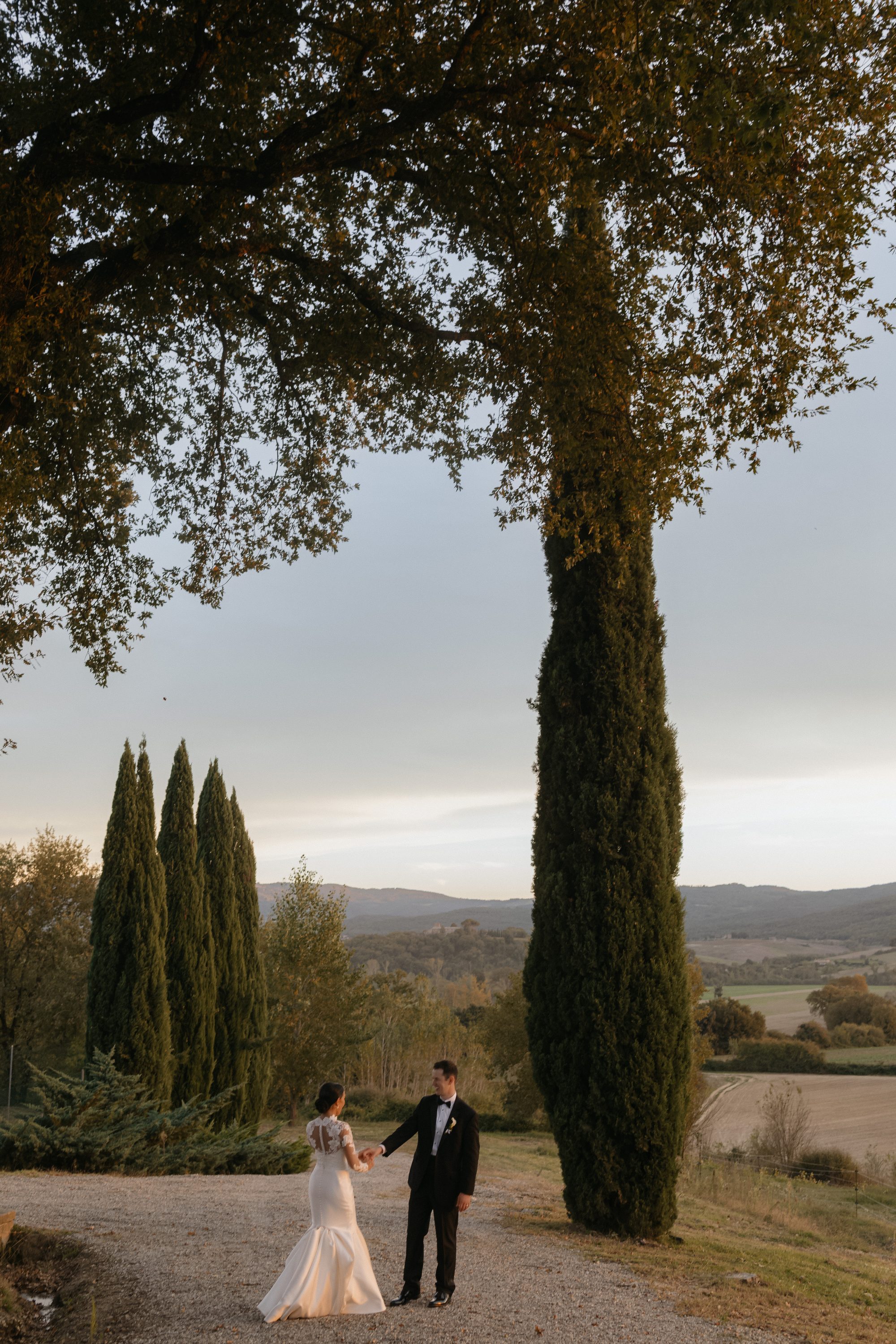 Kaitlin and Ryan walking among cypress trees