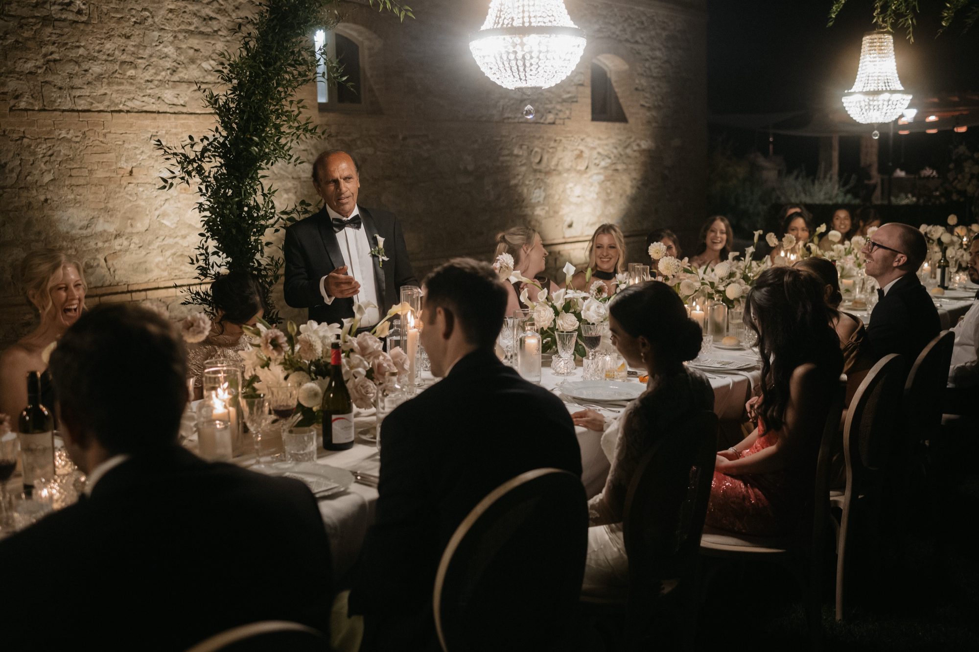 After party celebration under string lights at Tuscan destination wedding by Marco Wang