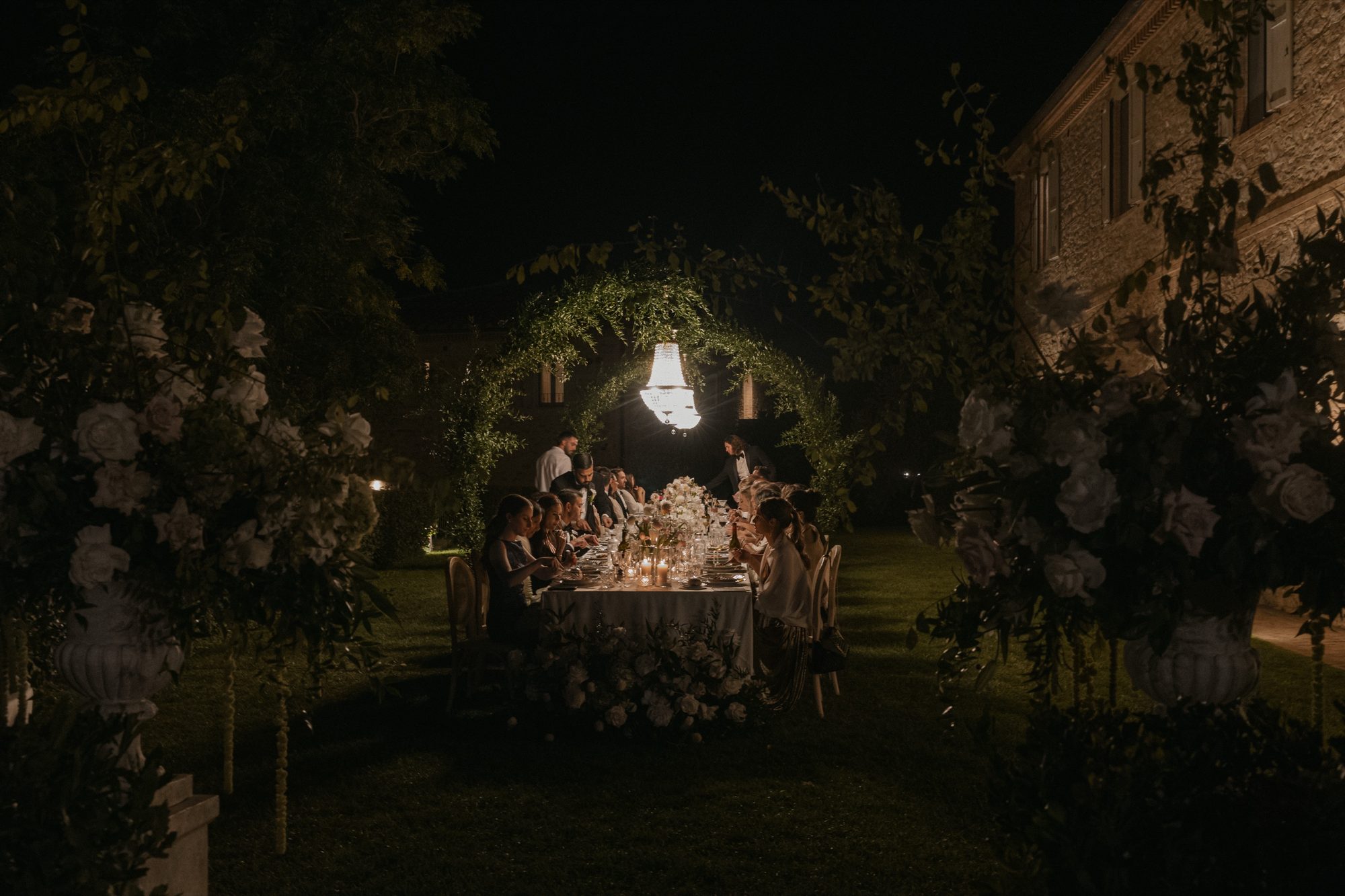 Wedding guests enjoying cocktails at Ombroneta Villa night reception Tuscany