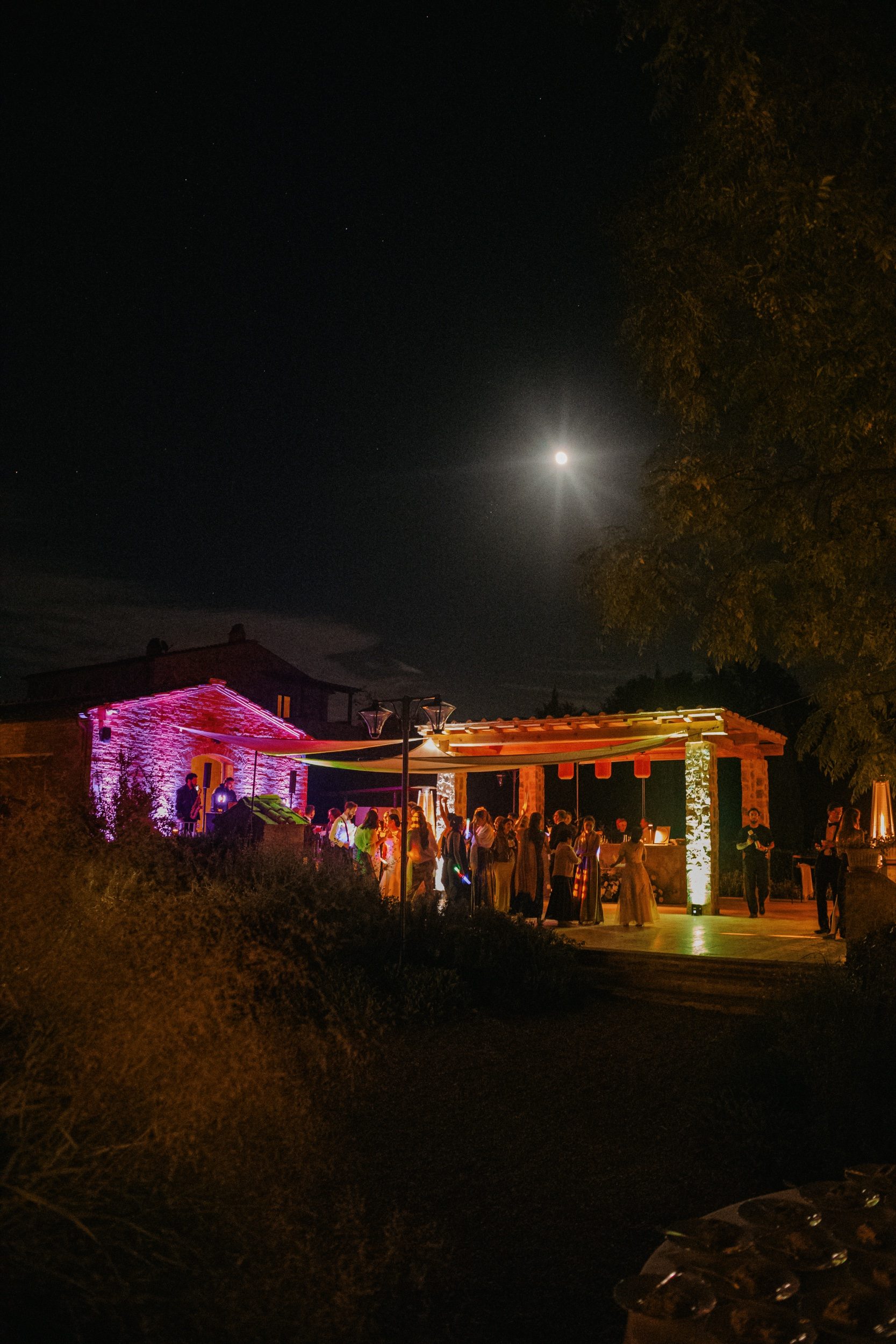 Guests laughing on dance floor at Tuscan villa after party celebration