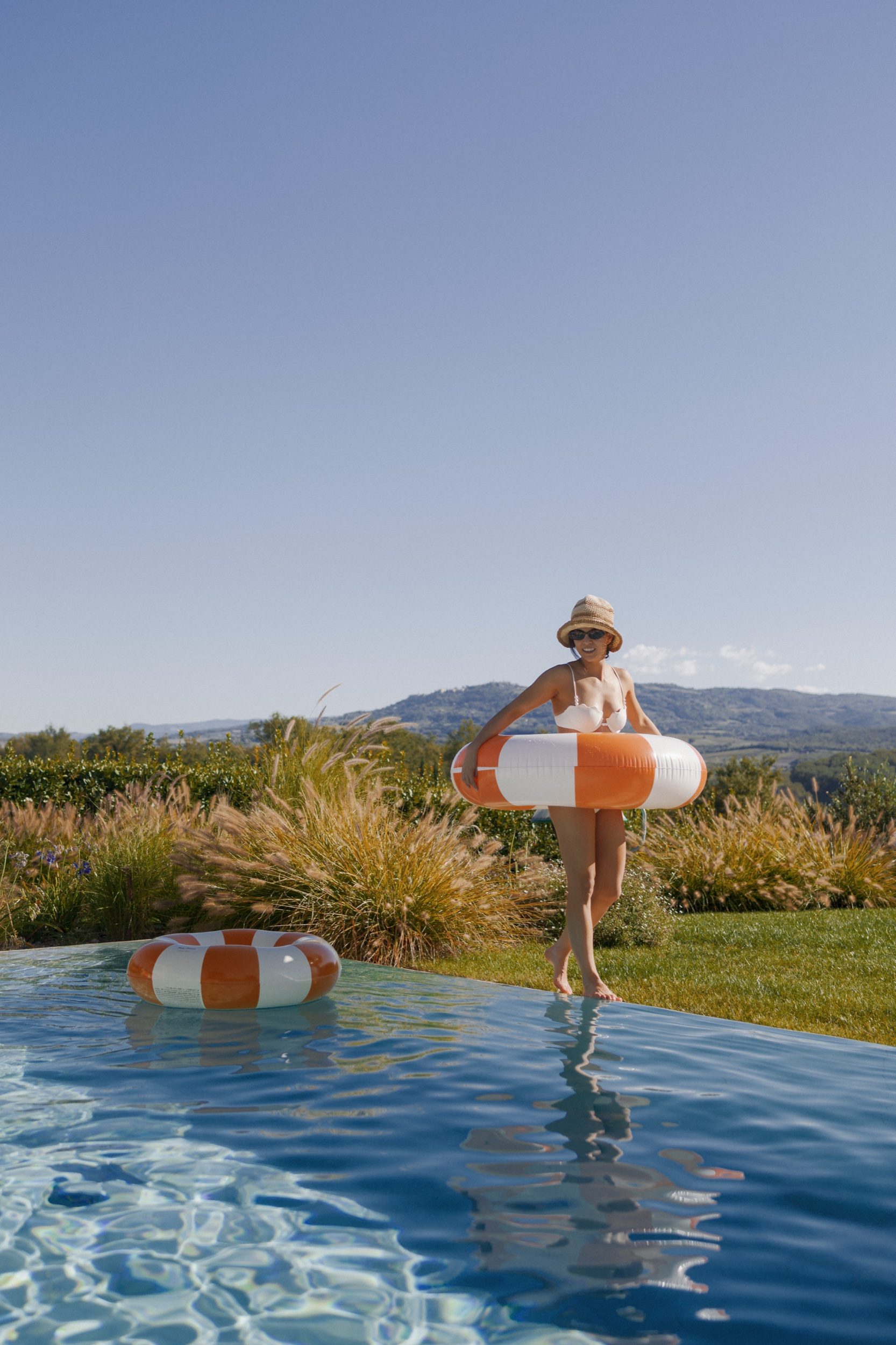 Poolside drinks and laughter at Ombroneta Estate Tuscany Italy by Marco Wang