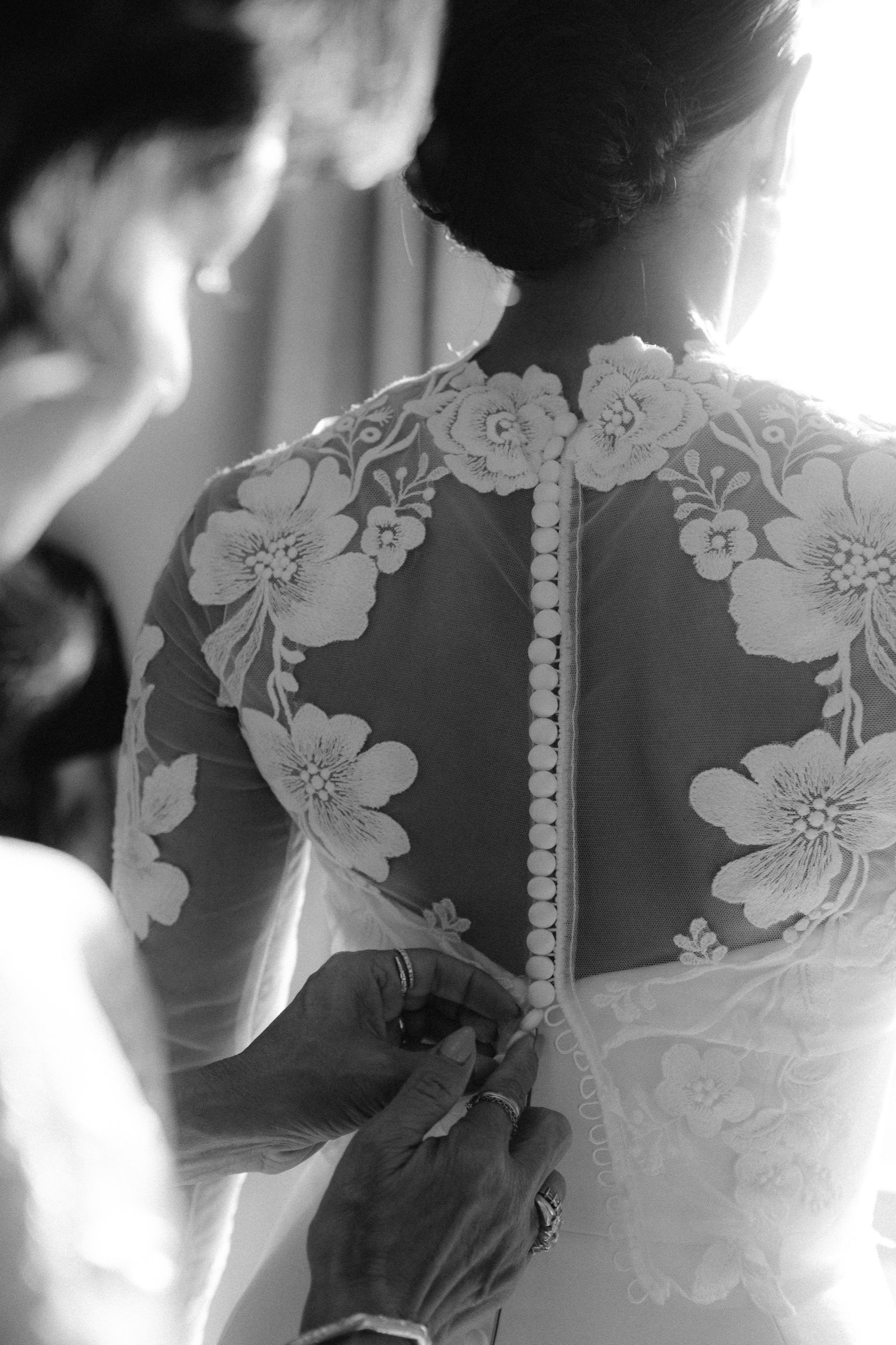 Wedding dress hanging in window with soft Tuscan morning light