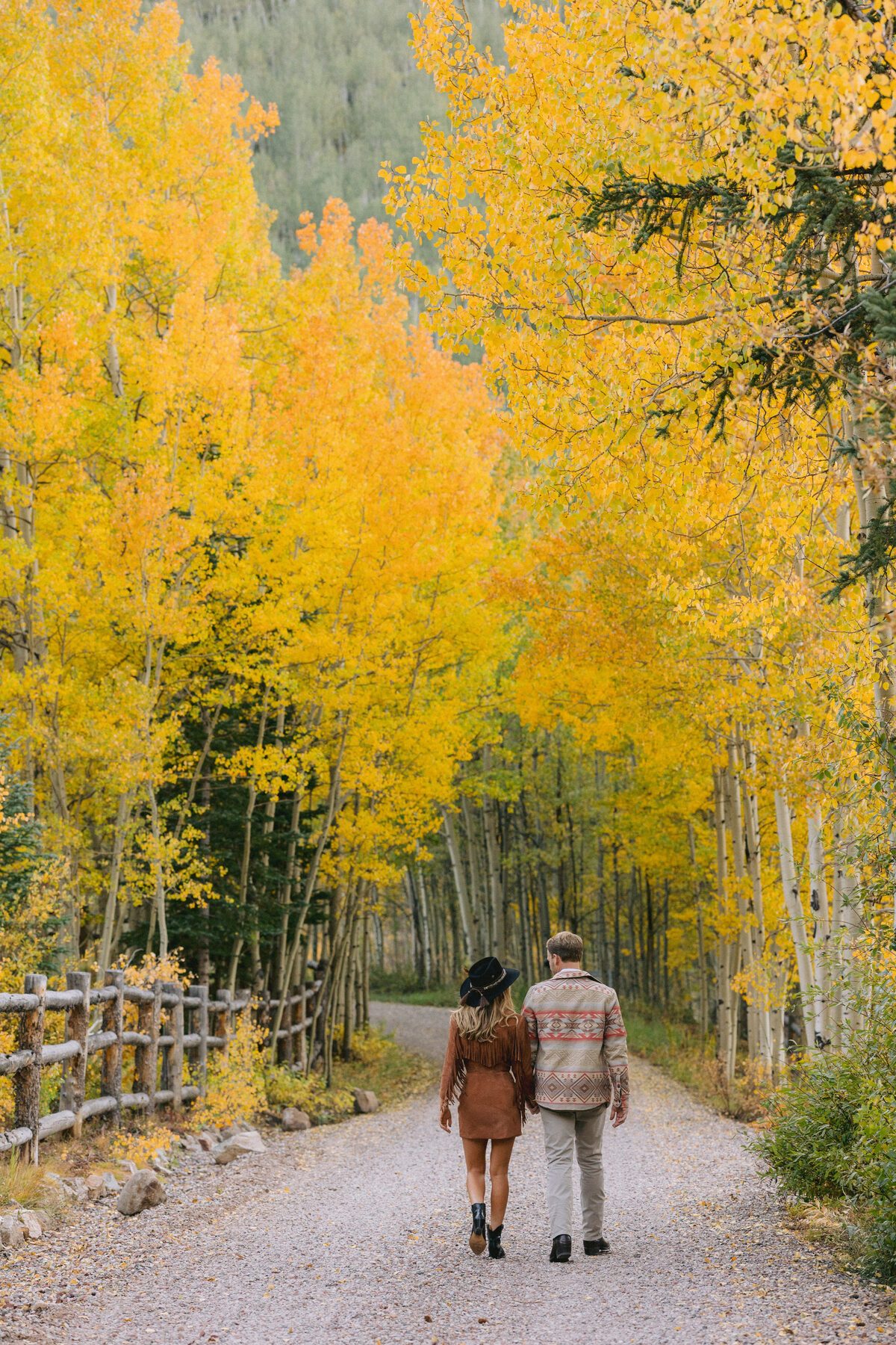 Intimate moment in aspen grove during fall engagement session Colorado