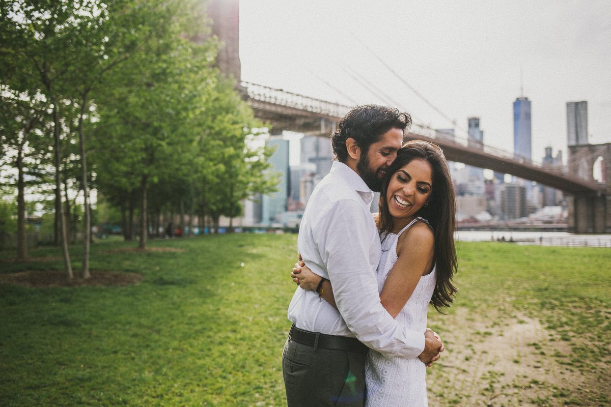Kavita and Amit walking together near the Brooklyn Bridge during their New York City engagement session by Marco Wang Photography