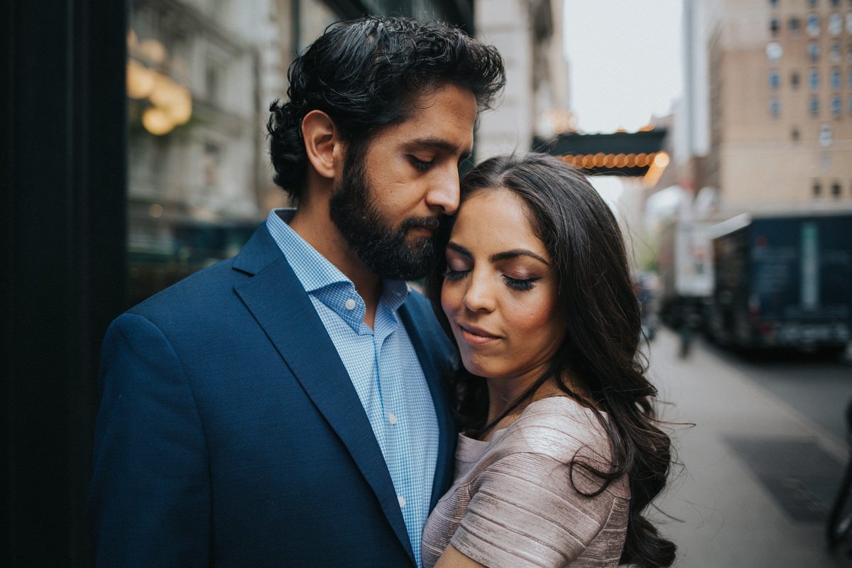 Kavita and Amit bathed in golden hour light on a Manhattan street during their NYC engagement session by Marco Wang Photography