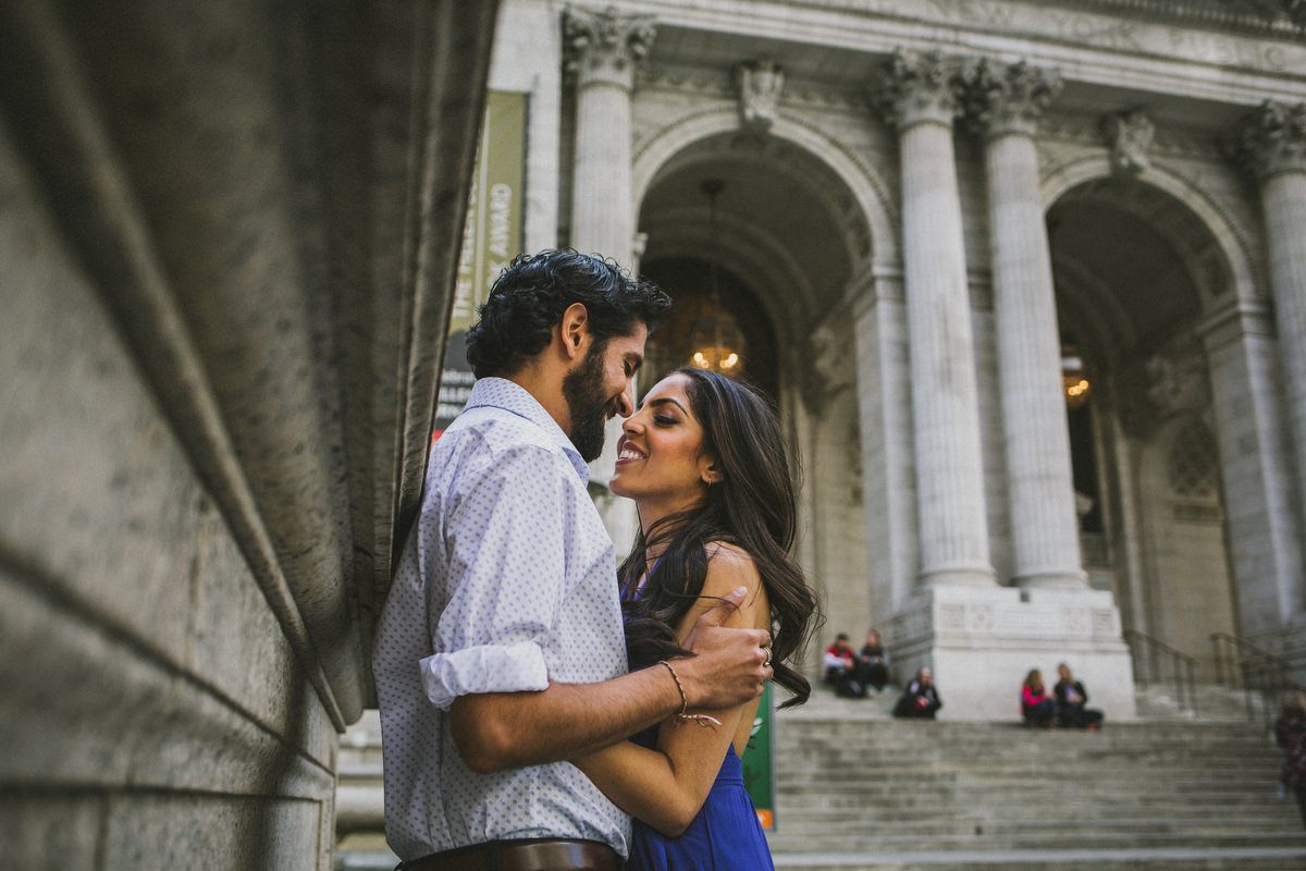 Kavita and Amit on the steps of the New York Public Library during their NYC engagement session by Houston photographer Marco Wang