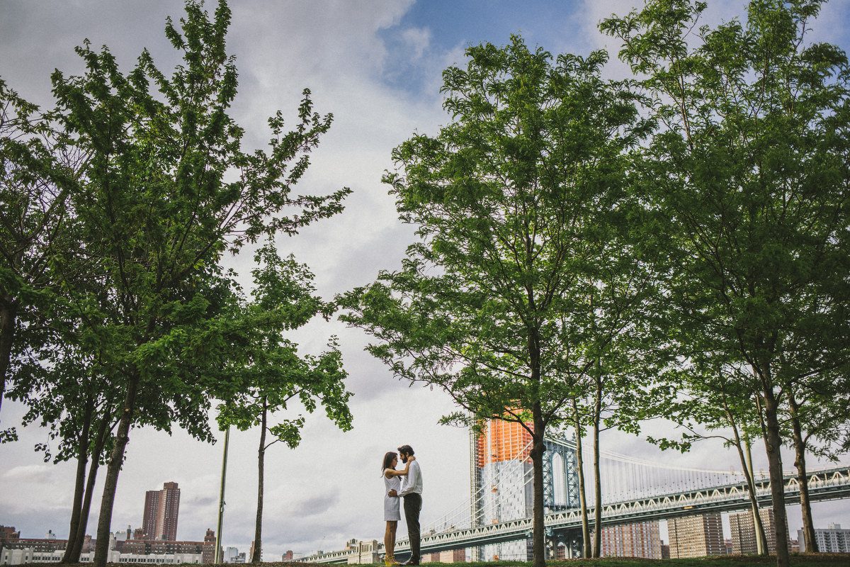Kavita and Amit strolling hand in hand through New York City streets during their engagement session by Houston photographer Marco Wang