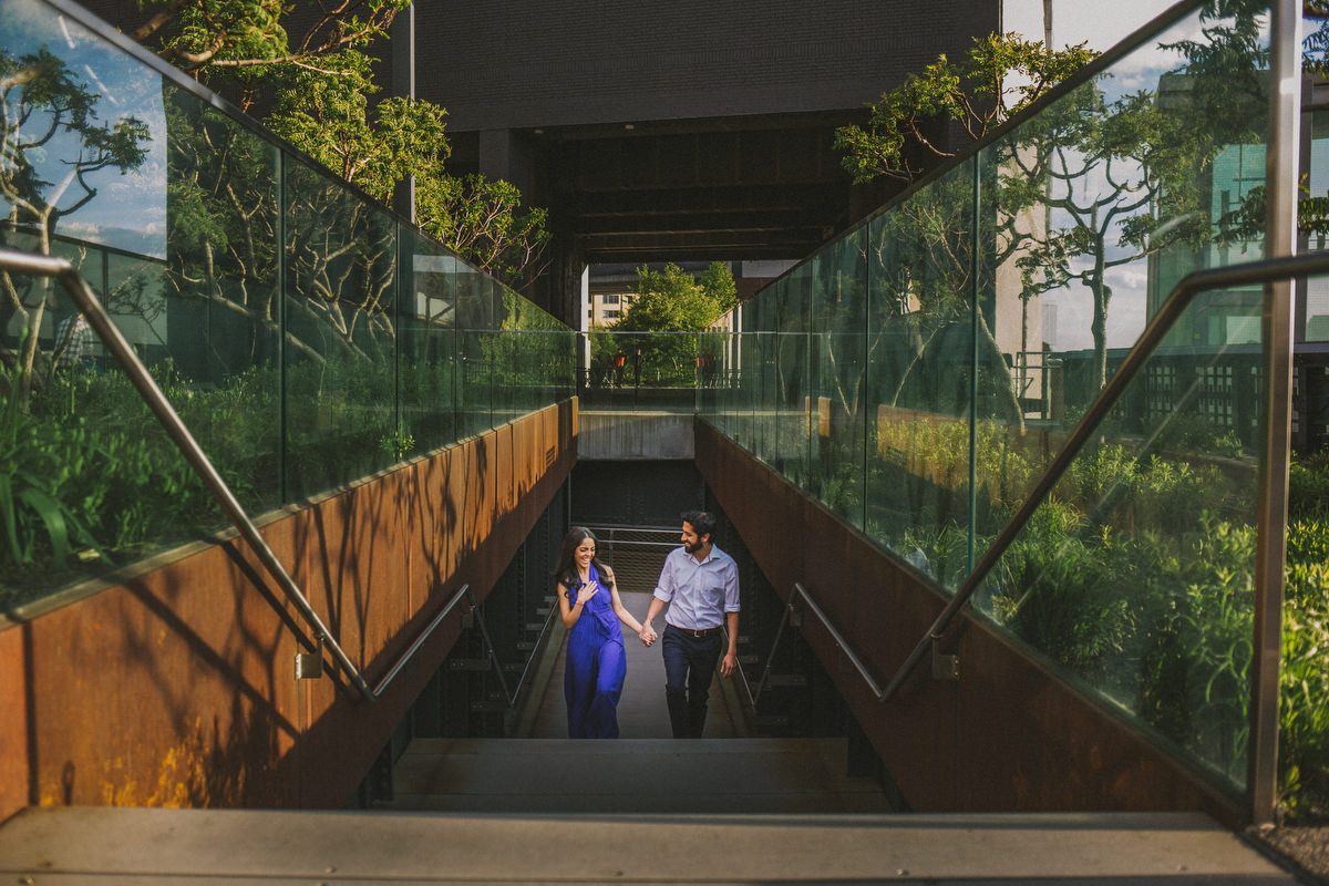 Kavita and Amit framed by iconic New York City urban architecture during their engagement session by Marco Wang Photography