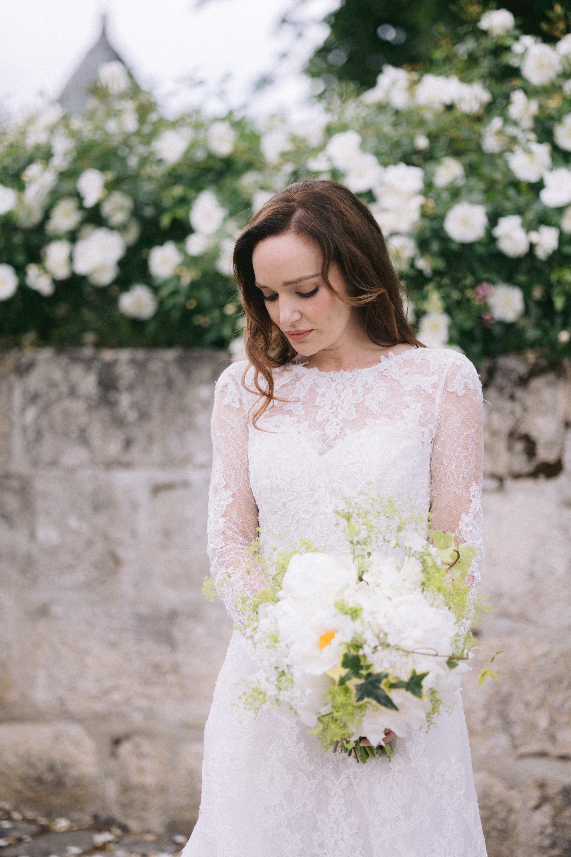 Bride with peony bouquet at Chateau de Farcheville destination wedding