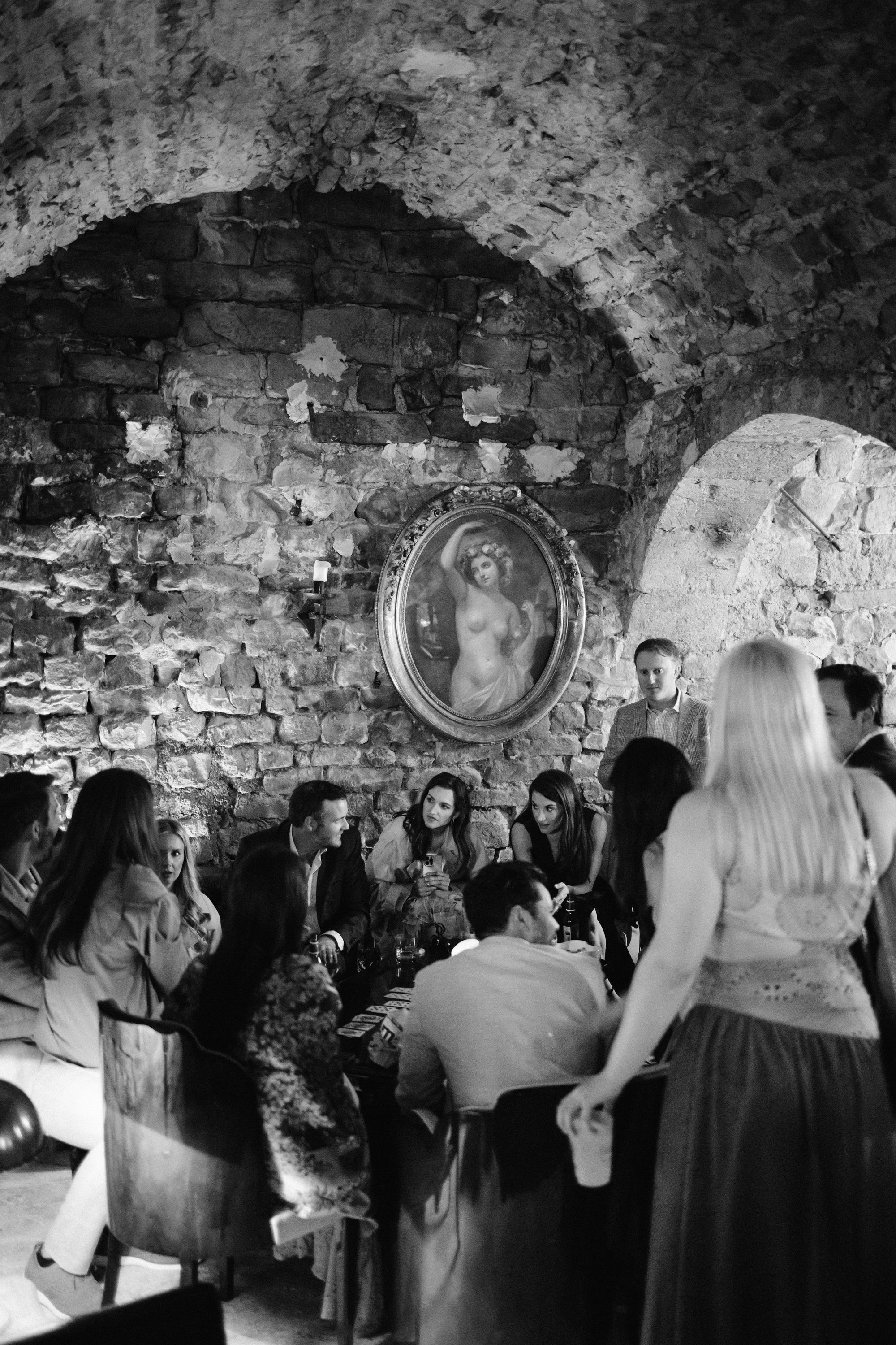 Cocktail hour in stone cellar at Chateau de Farcheville France destination wedding