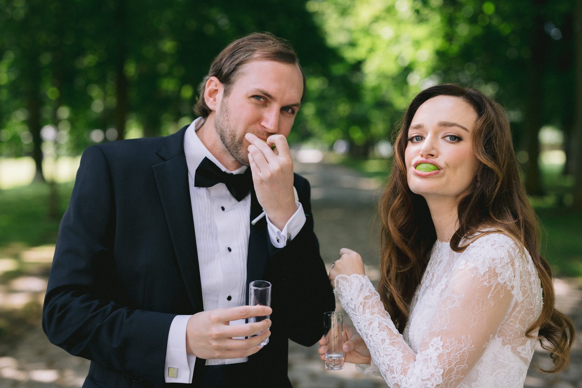 Playful couple moment with champagne at French chateau wedding
