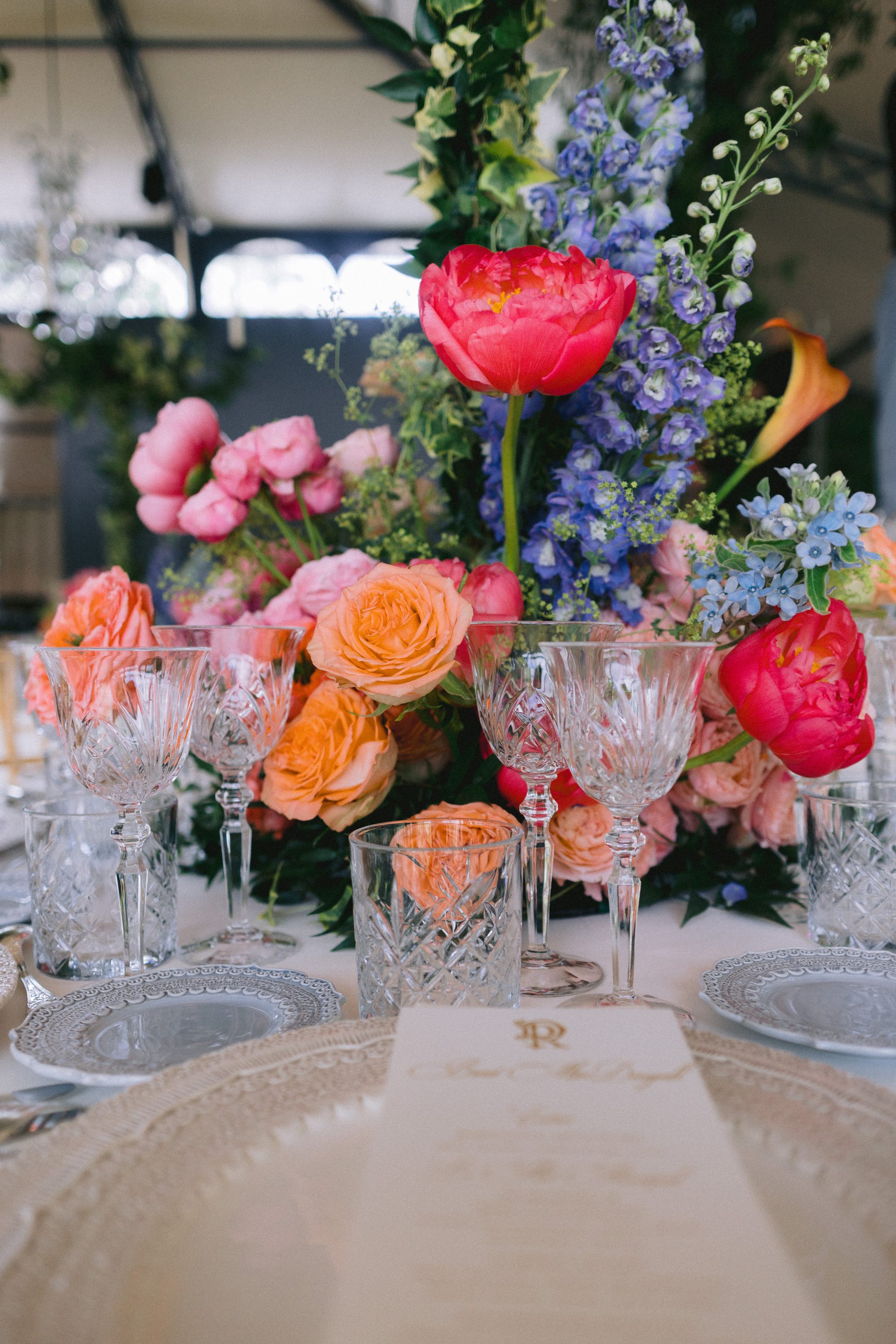 Reception table with colorful floral centerpiece Chateau de Farcheville wedding